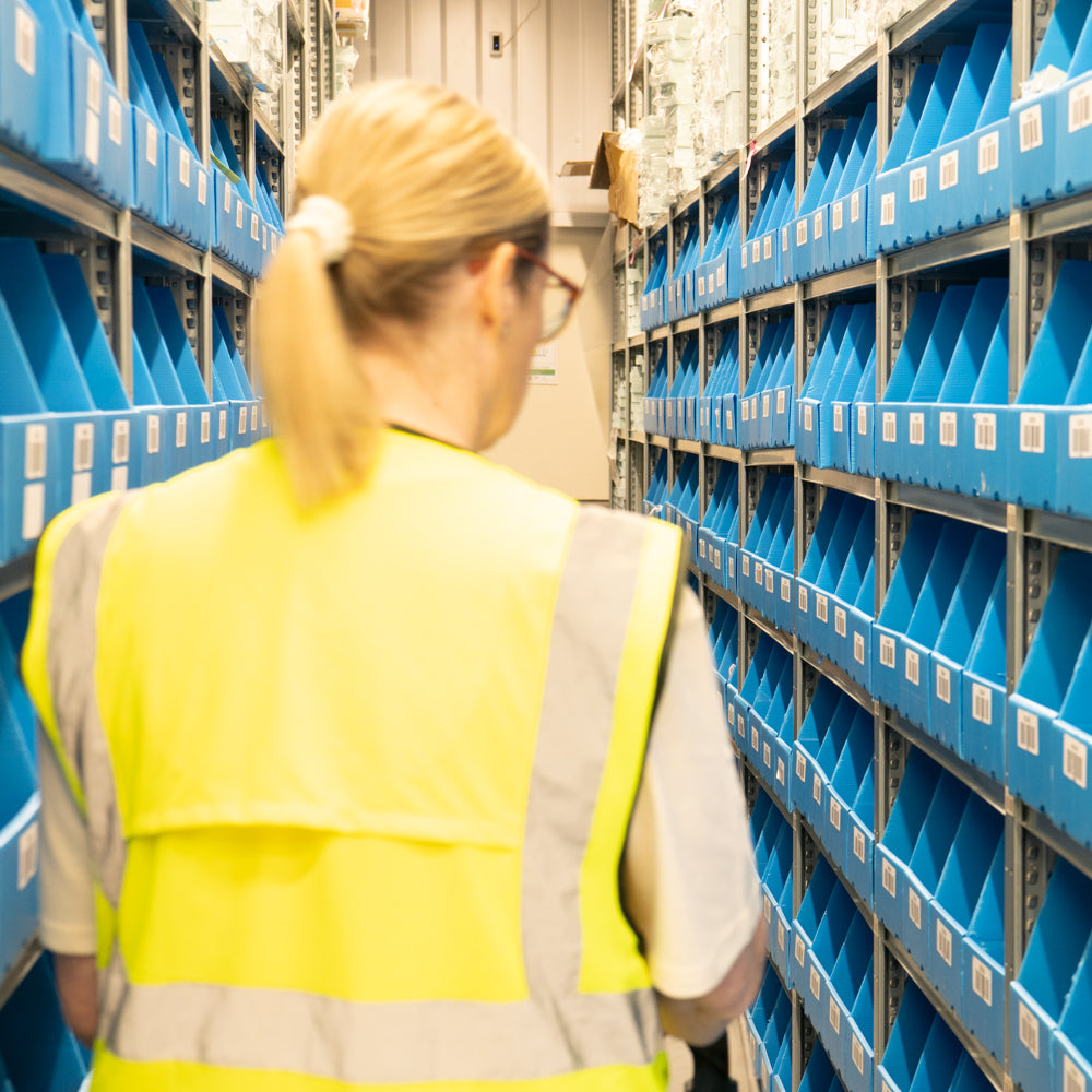 Team Member Picking Stock from the Warehouse Blue Stock Boxes