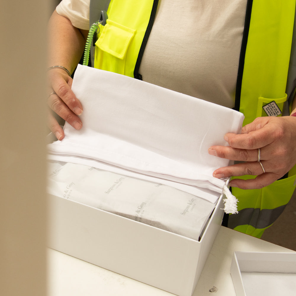Team Member Packing some Shoes with Care
