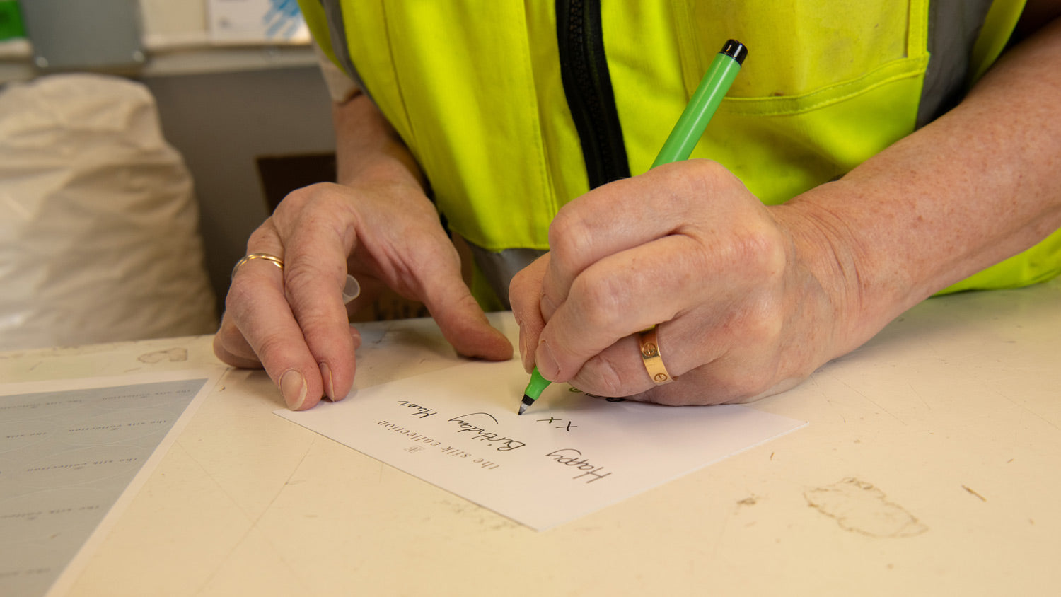 Team Member Writing a Gift Card at the UK Fulfilment Centre 