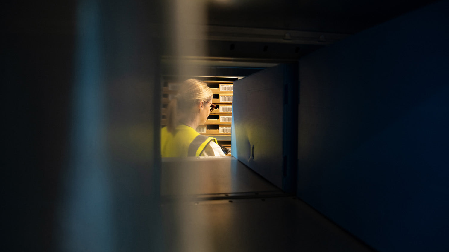 Team Member in the Picking Area with the Small Storage Boxes