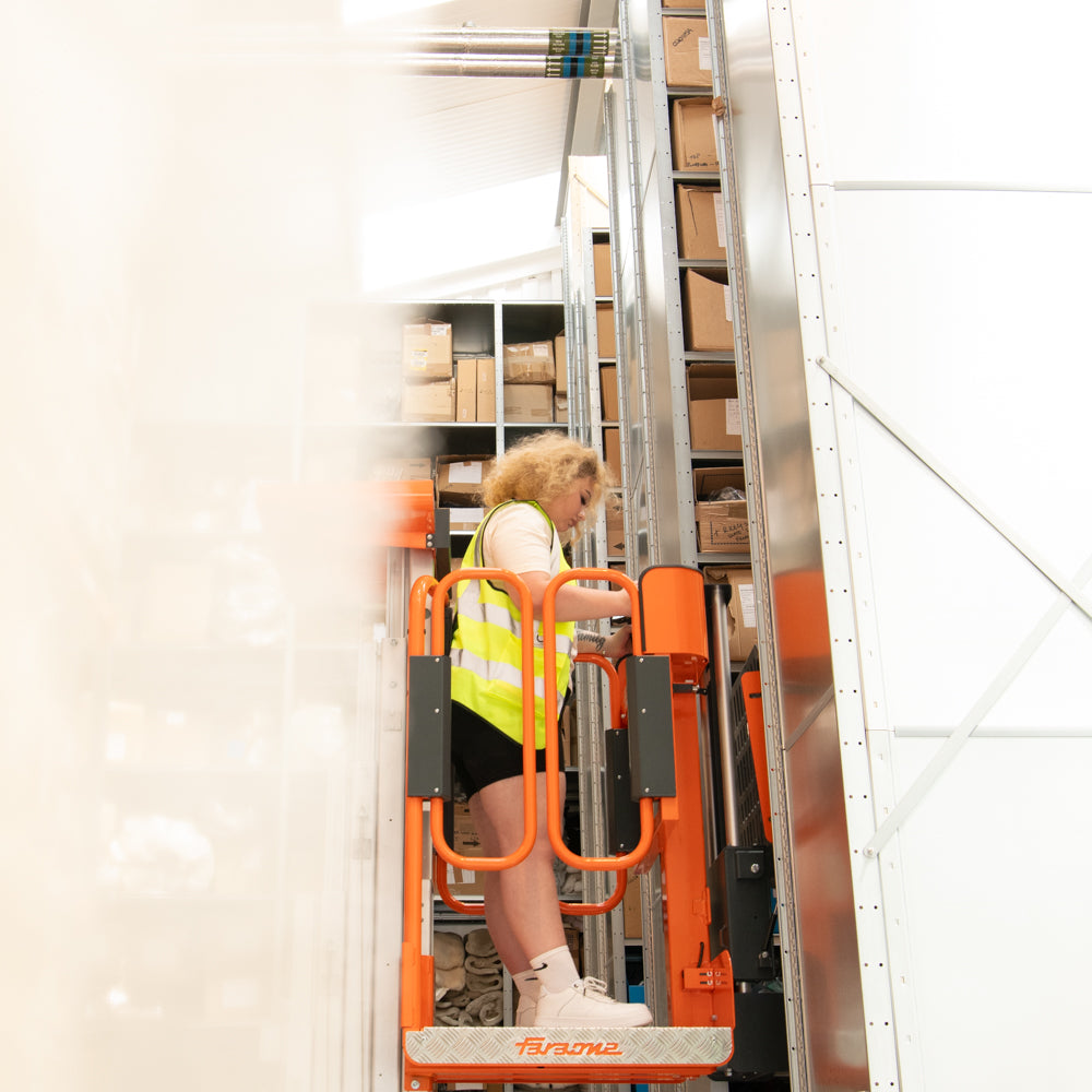 Warehouse Team Member using a Lift  to see Stock