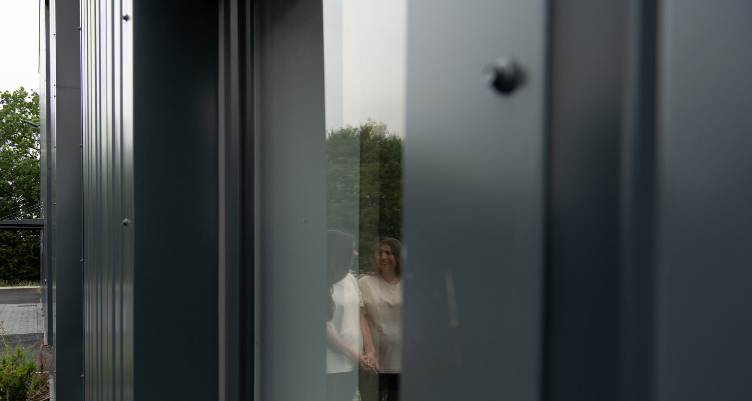 Co Founders Avril and Sophie in Reflection of Fulfilment Centre Windows